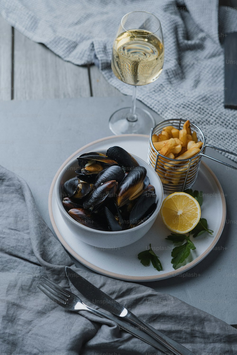 a plate of mussels and a glass of wine