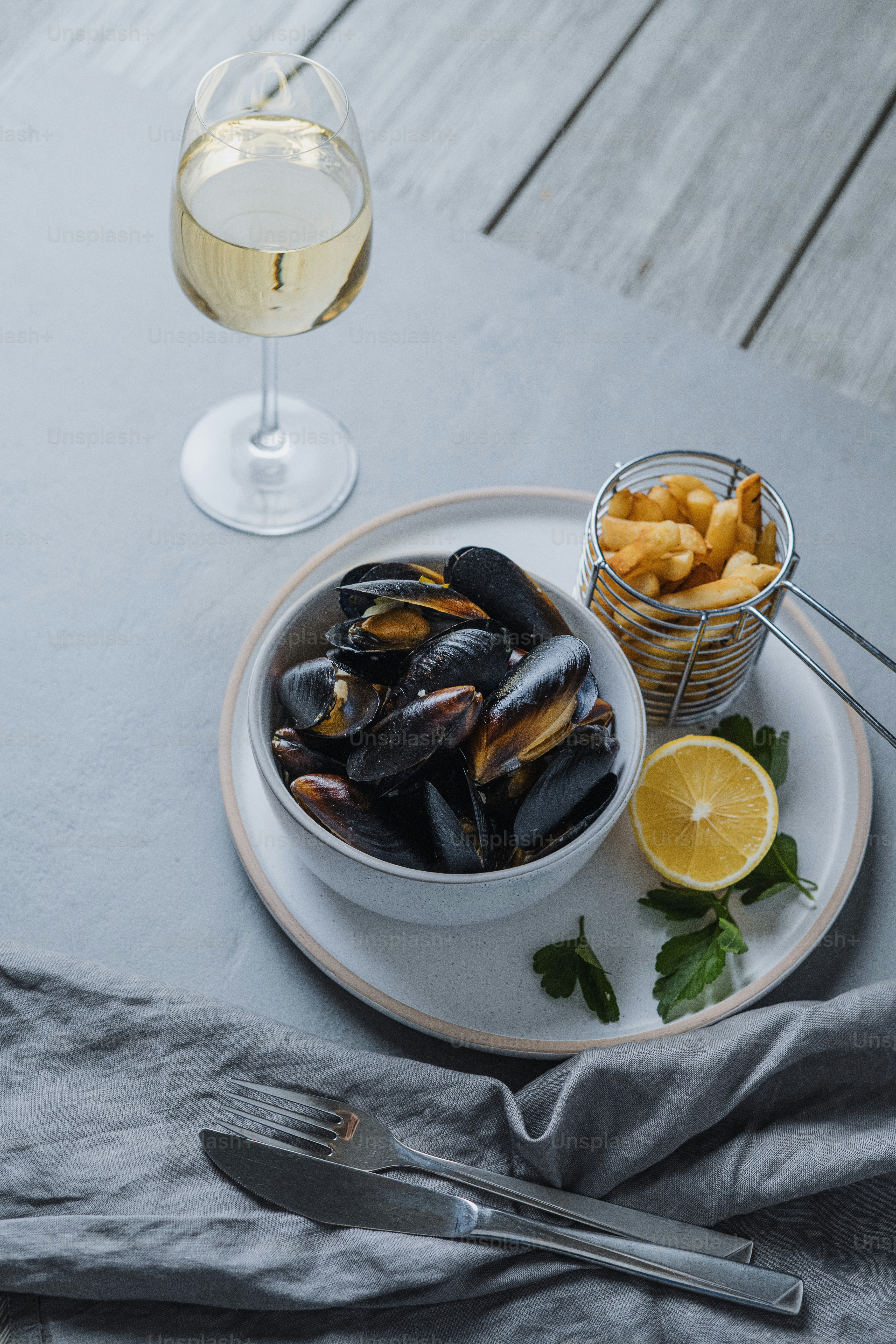a plate of mussels and a glass of wine