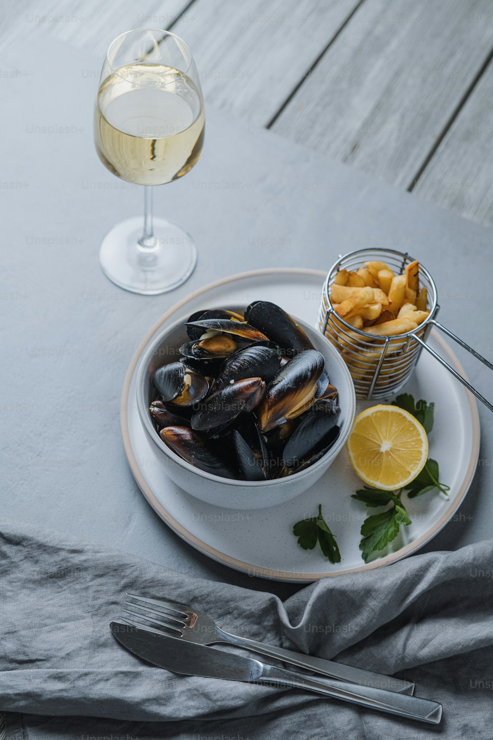 a plate of mussels and a glass of wine