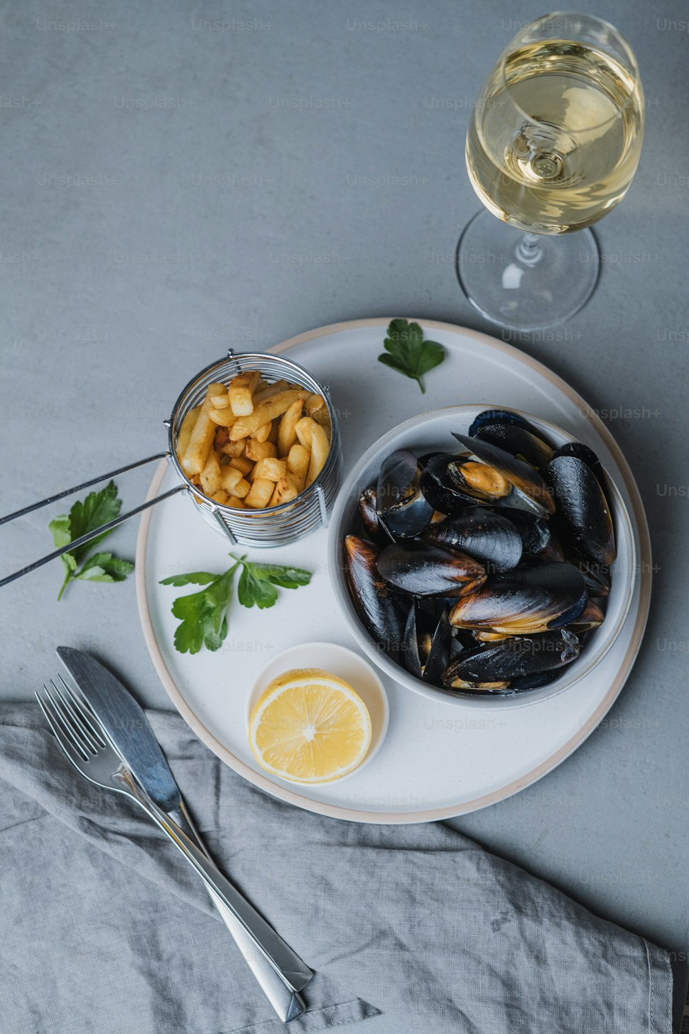 a plate of mussels and a glass of wine