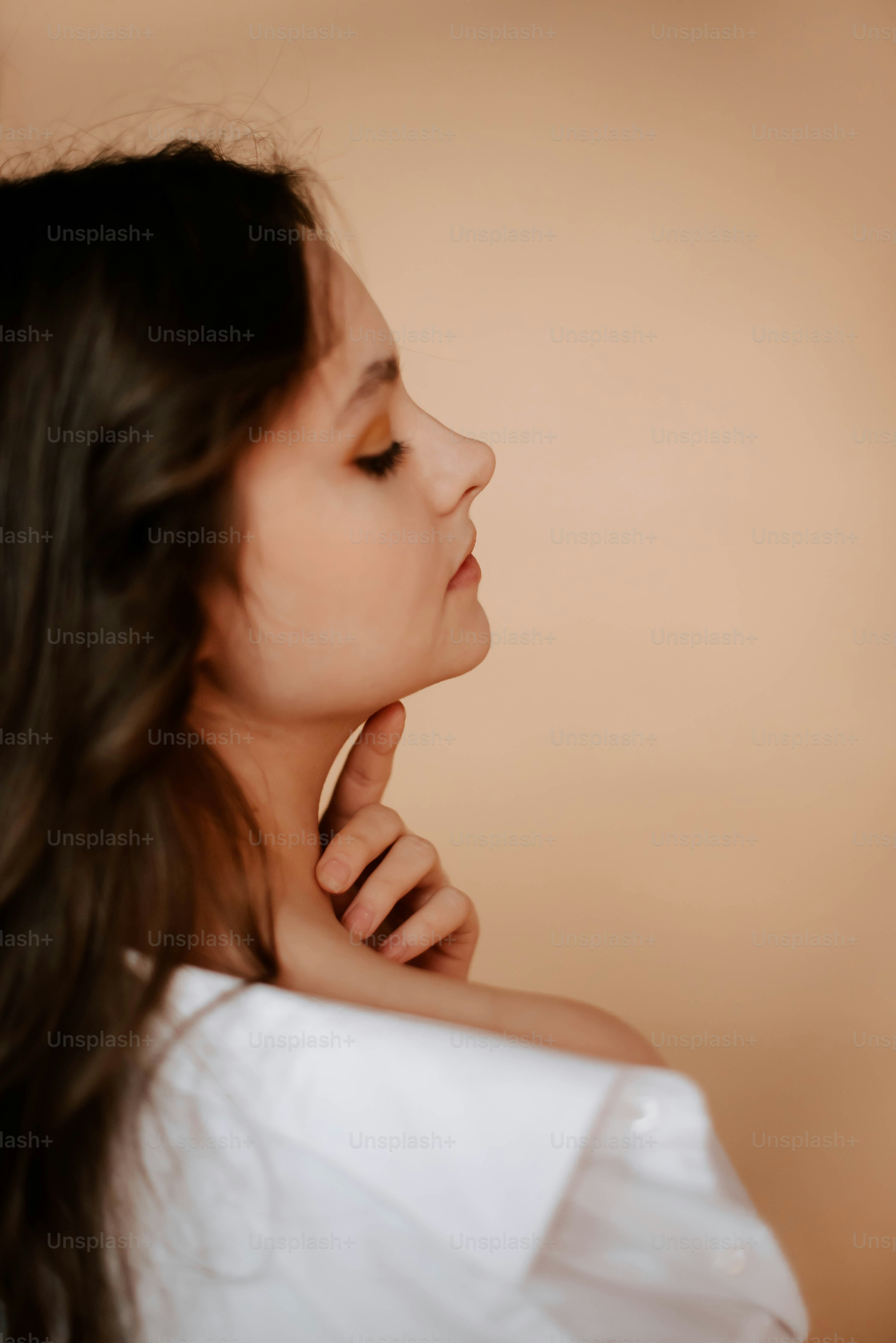 a woman in a white shirt is posing for a picture