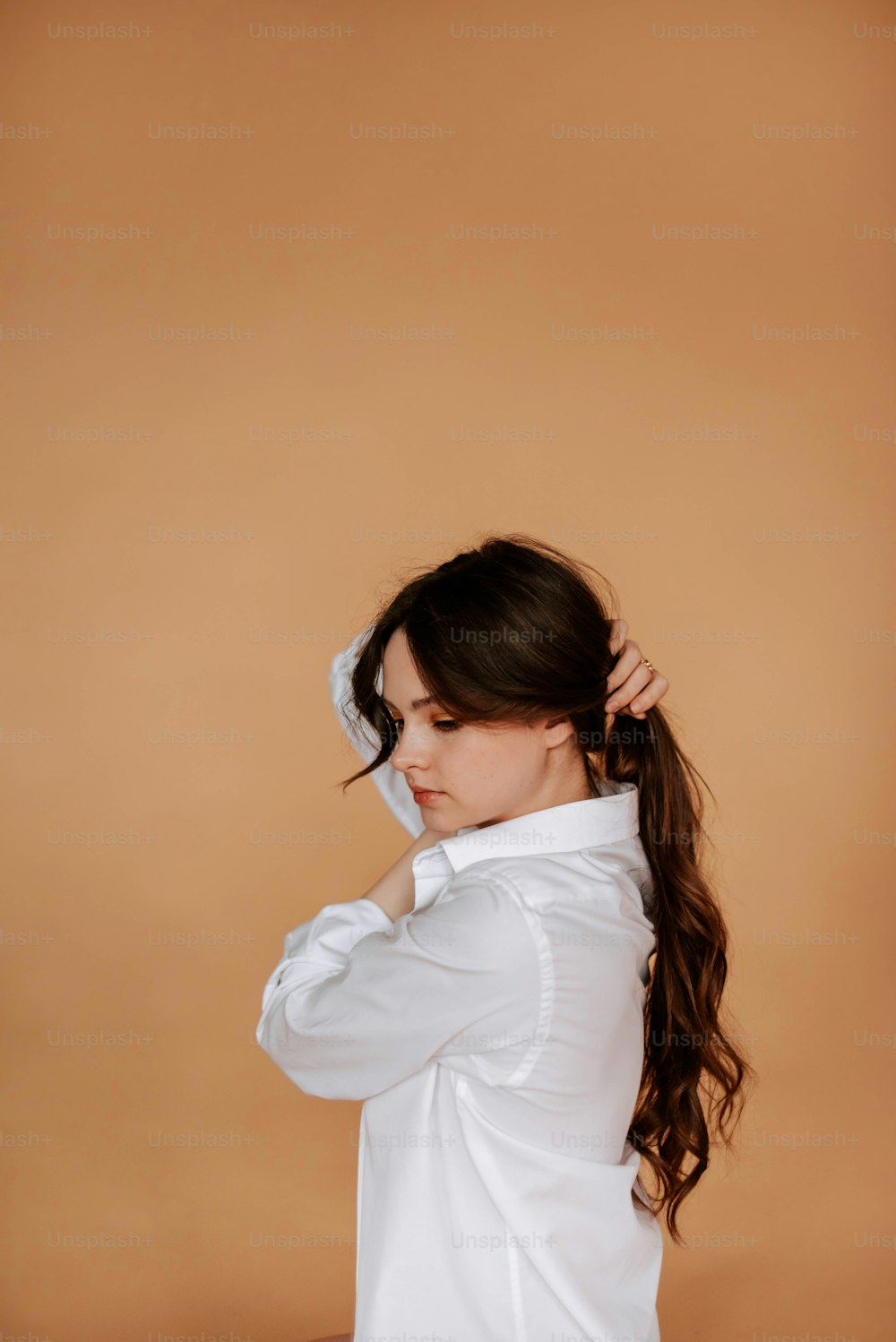 a woman with long hair wearing a white shirt