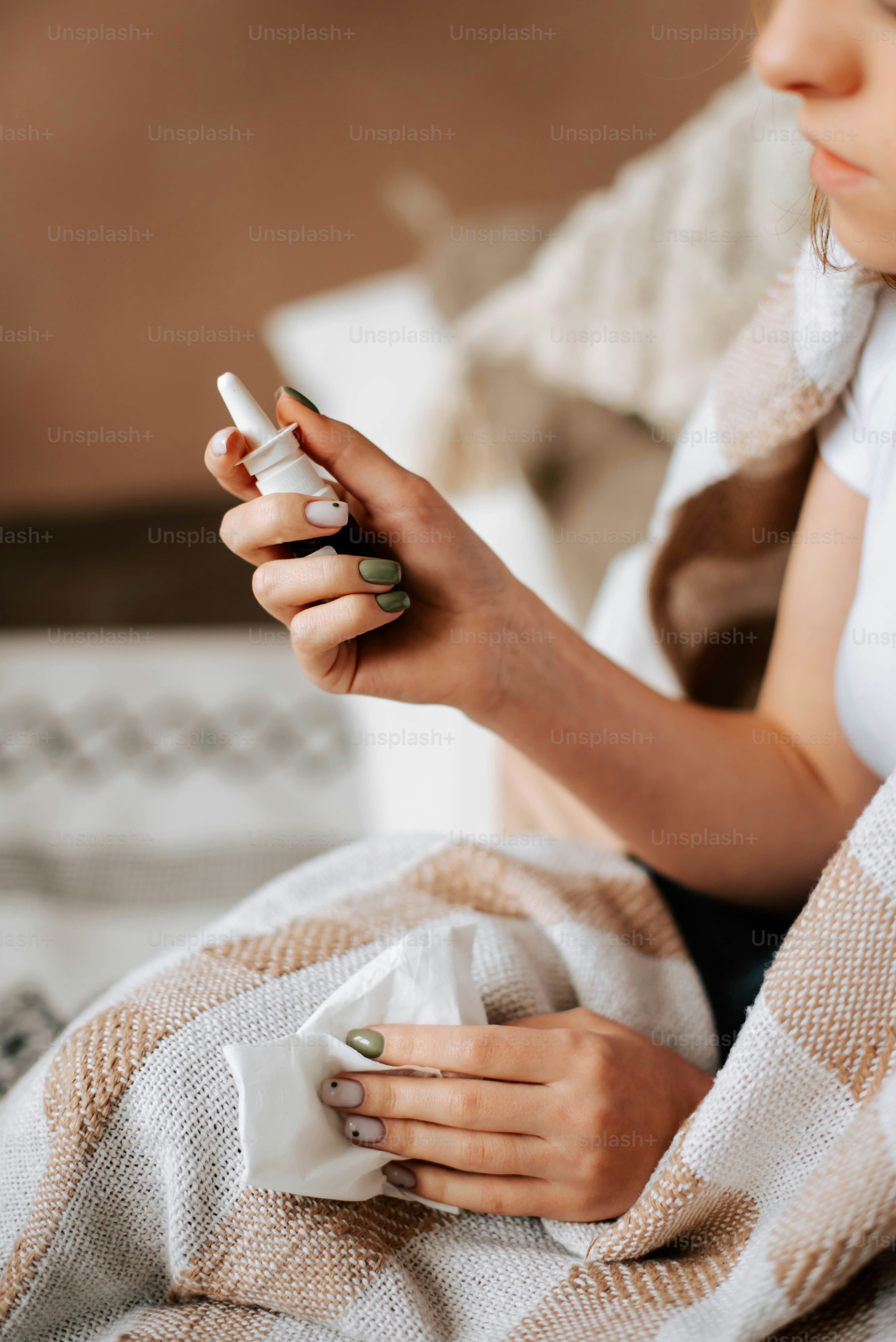 a woman sitting on a bed holding a cup of coffee