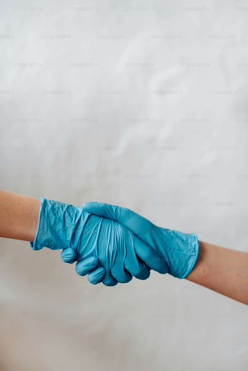 a pair of blue gloves on a person's arm