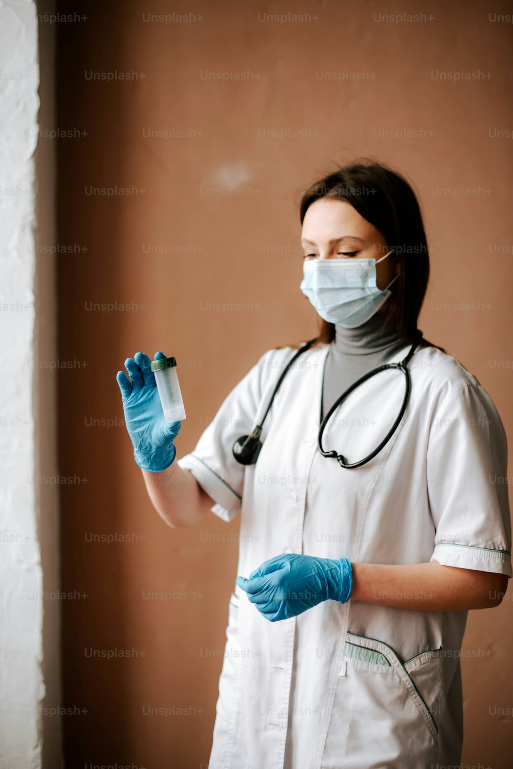 a female nurse wearing a mask and gloves