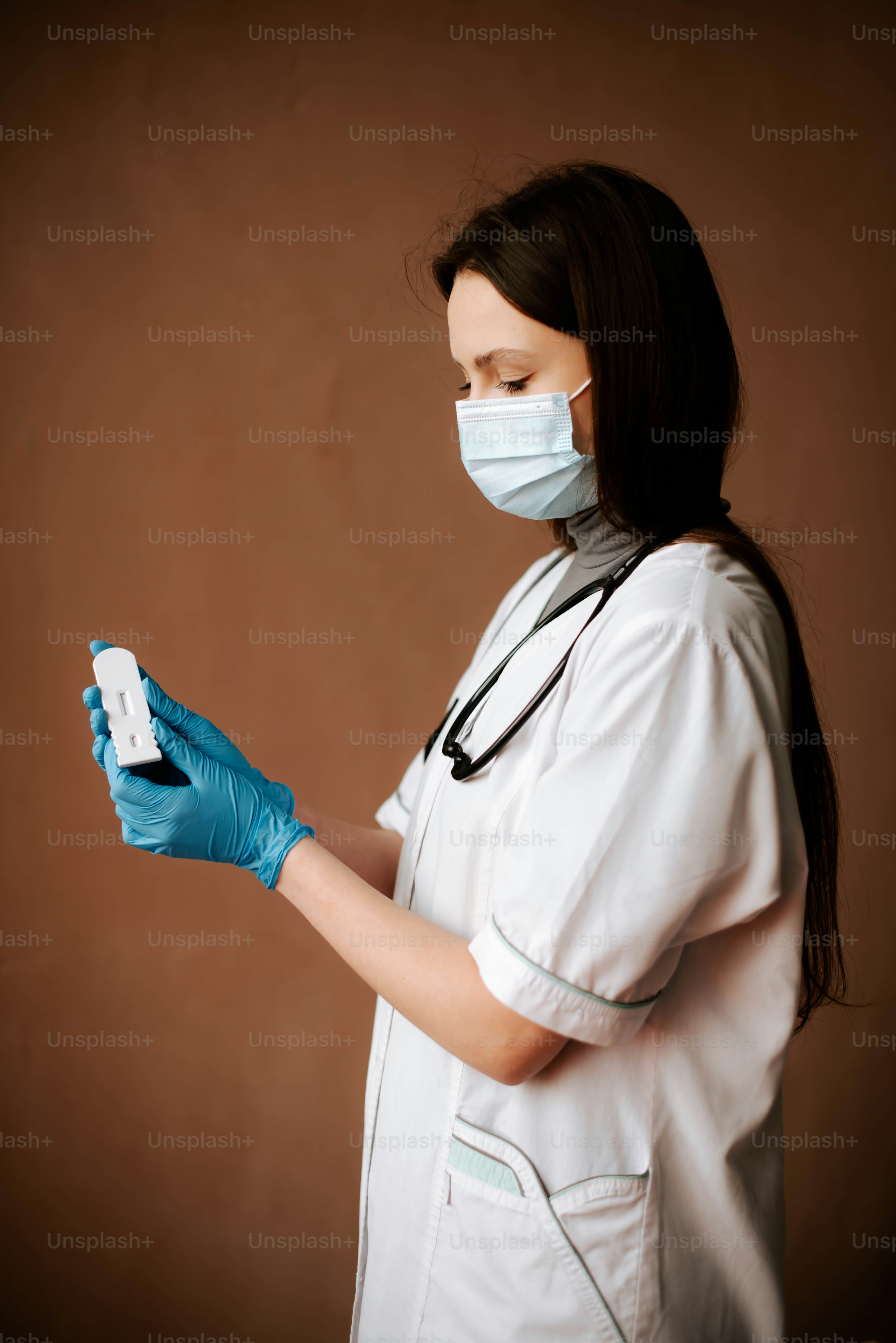 A woman wearing a surgical mask and gloves photo – Healthcare Image on ...