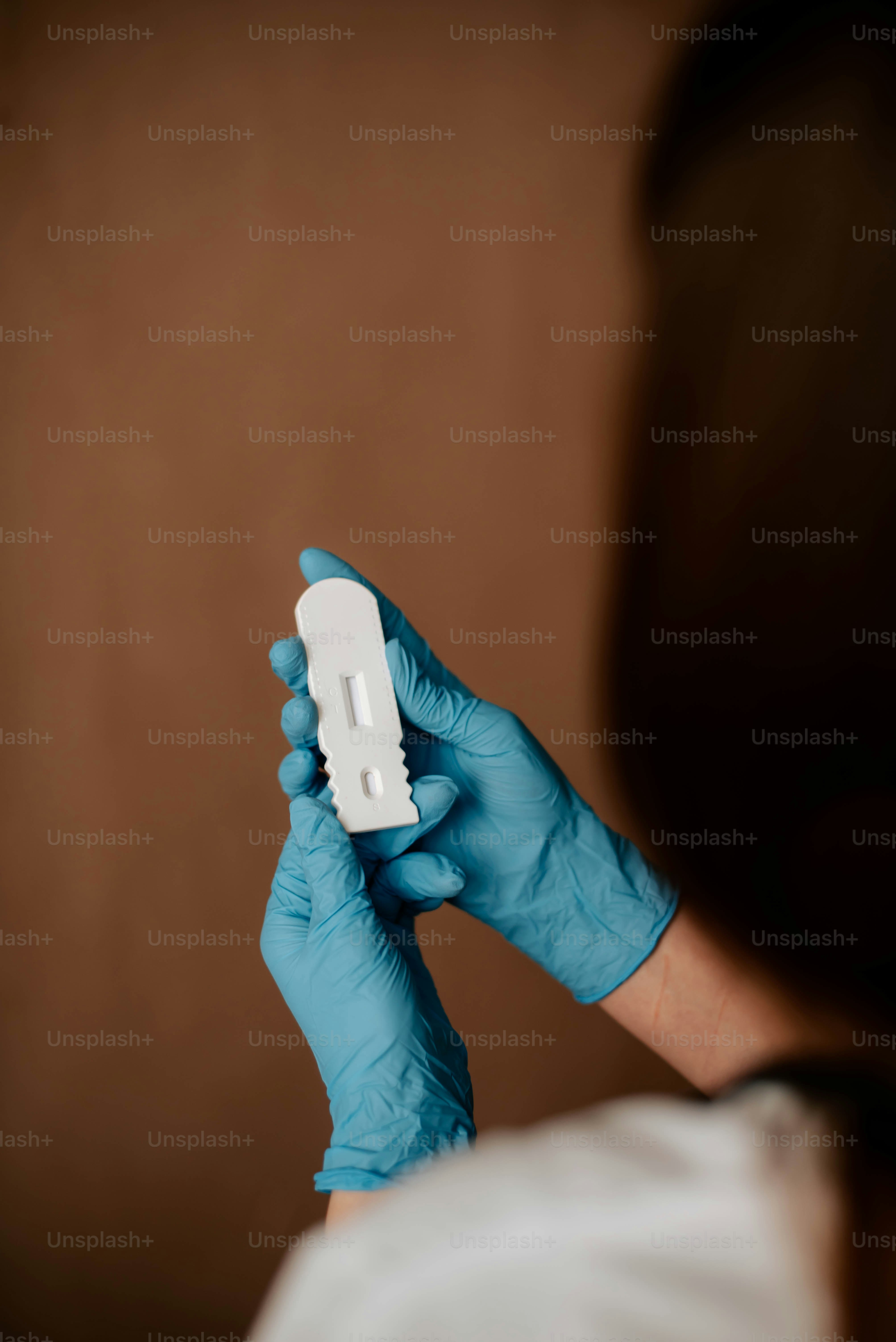 a person in blue gloves holding a wii remote