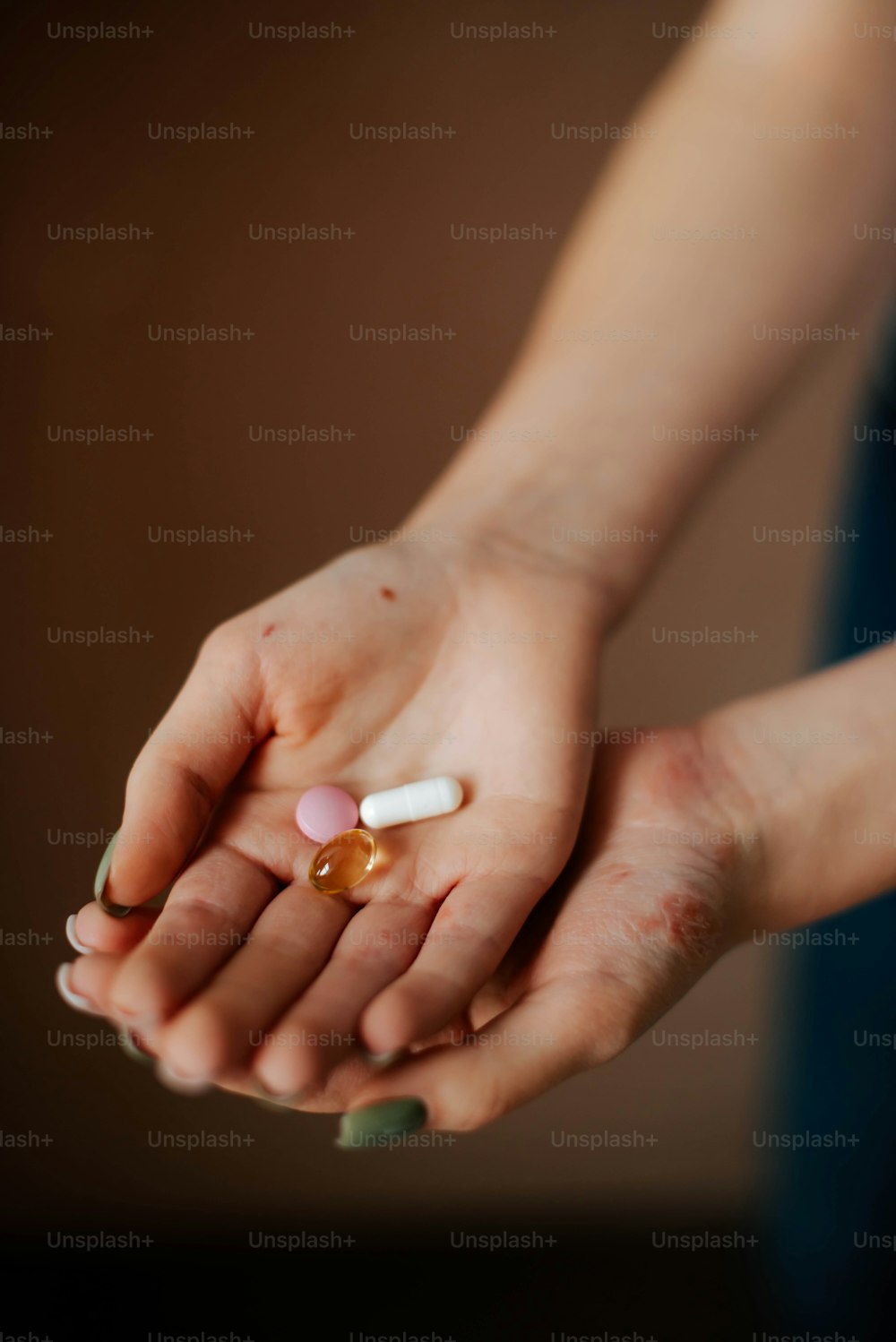 a person holding a pill in their hand