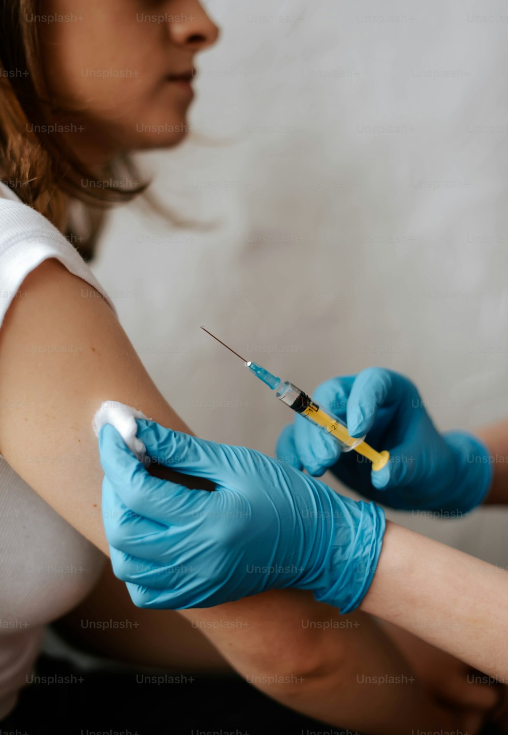 a woman getting a vaccium vaccium from a needle