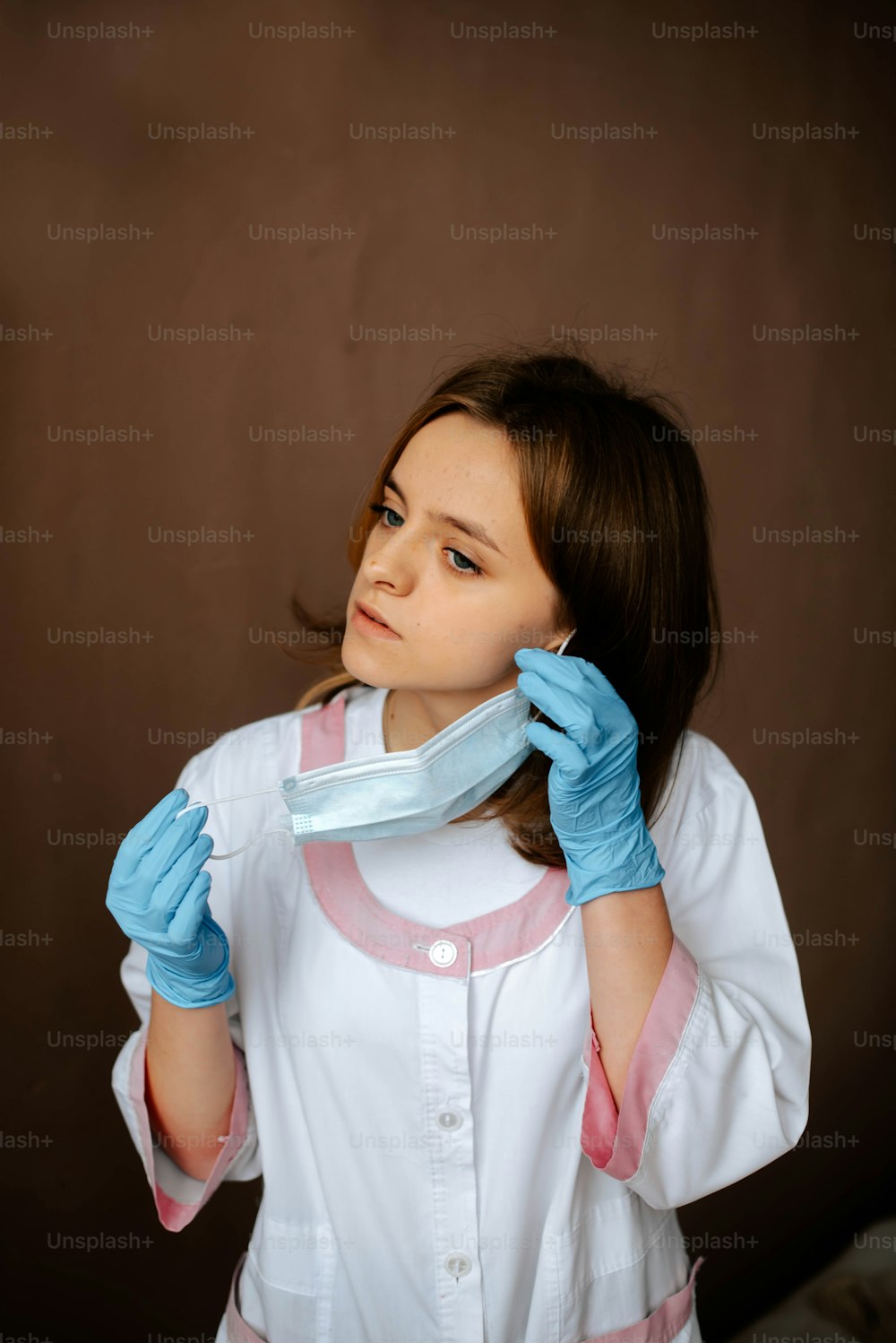 a girl in a white shirt and blue gloves
