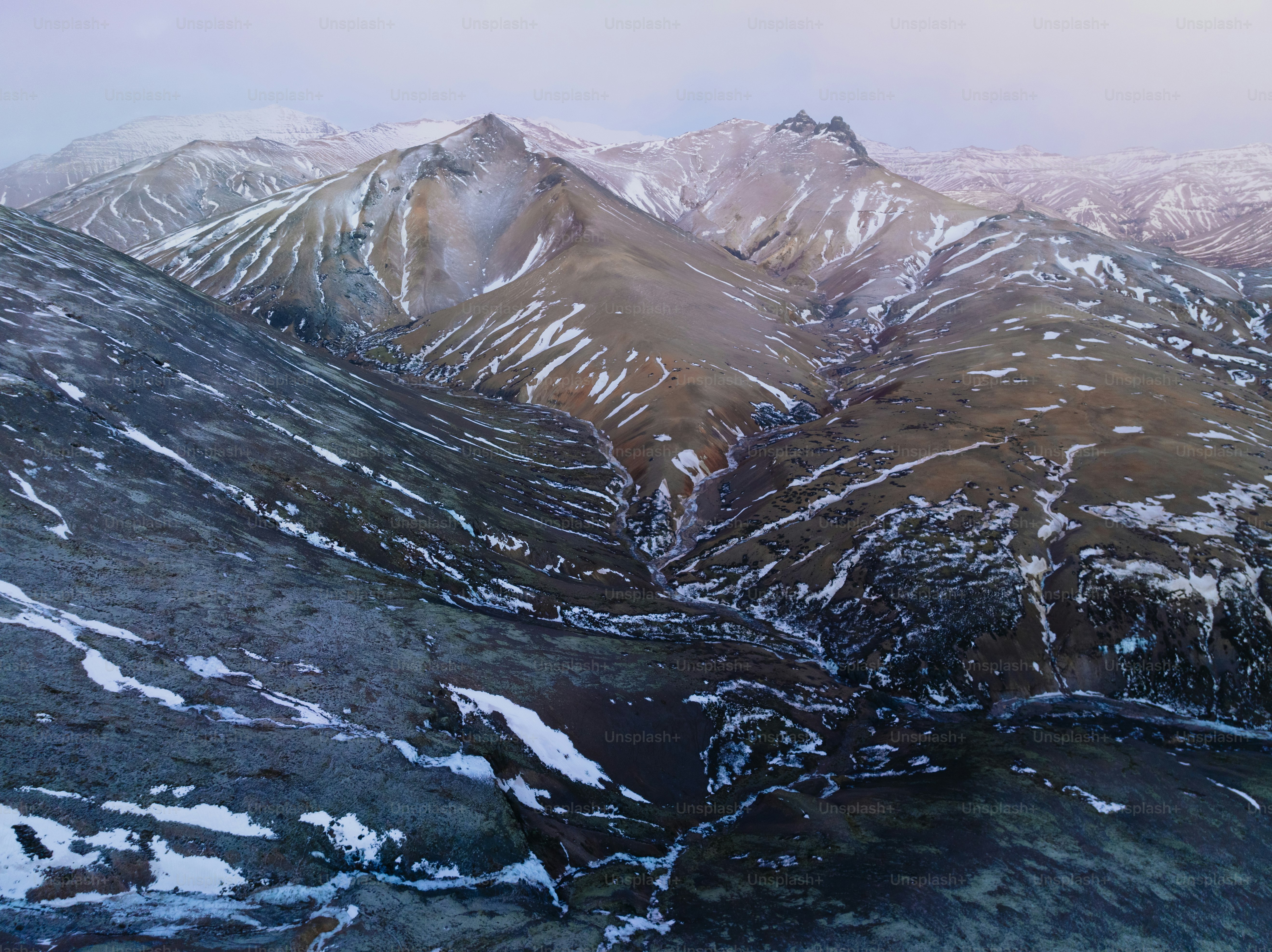 a mountain range covered in snow in the winter