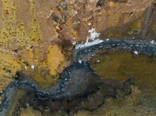 an aerial view of a river in a rocky area