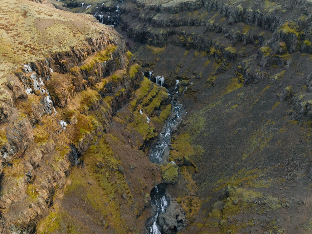an aerial view of a canyon with a waterfall