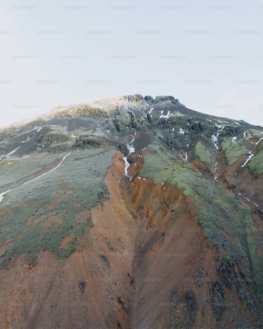 a very large mountain with some snow on it