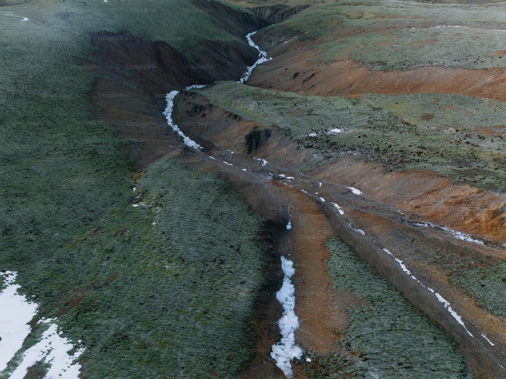 an aerial view of a valley with snow on the ground
