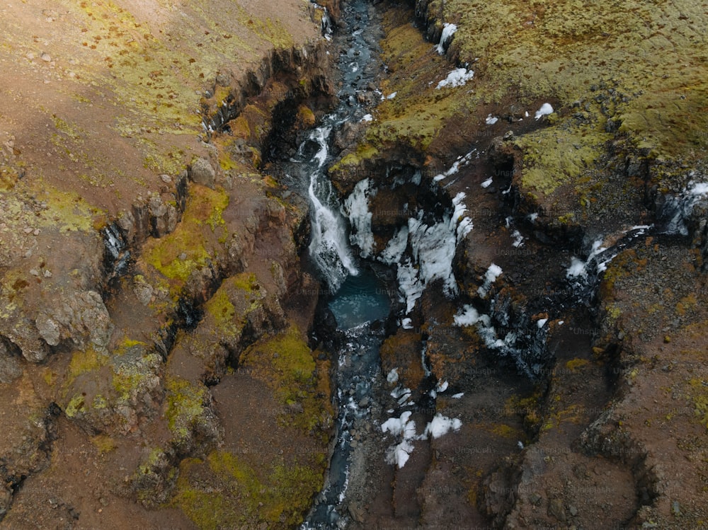 an aerial view of a stream in a rocky area