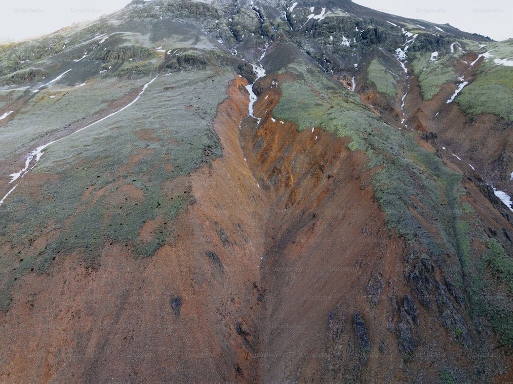 an aerial view of a mountain with snow on it