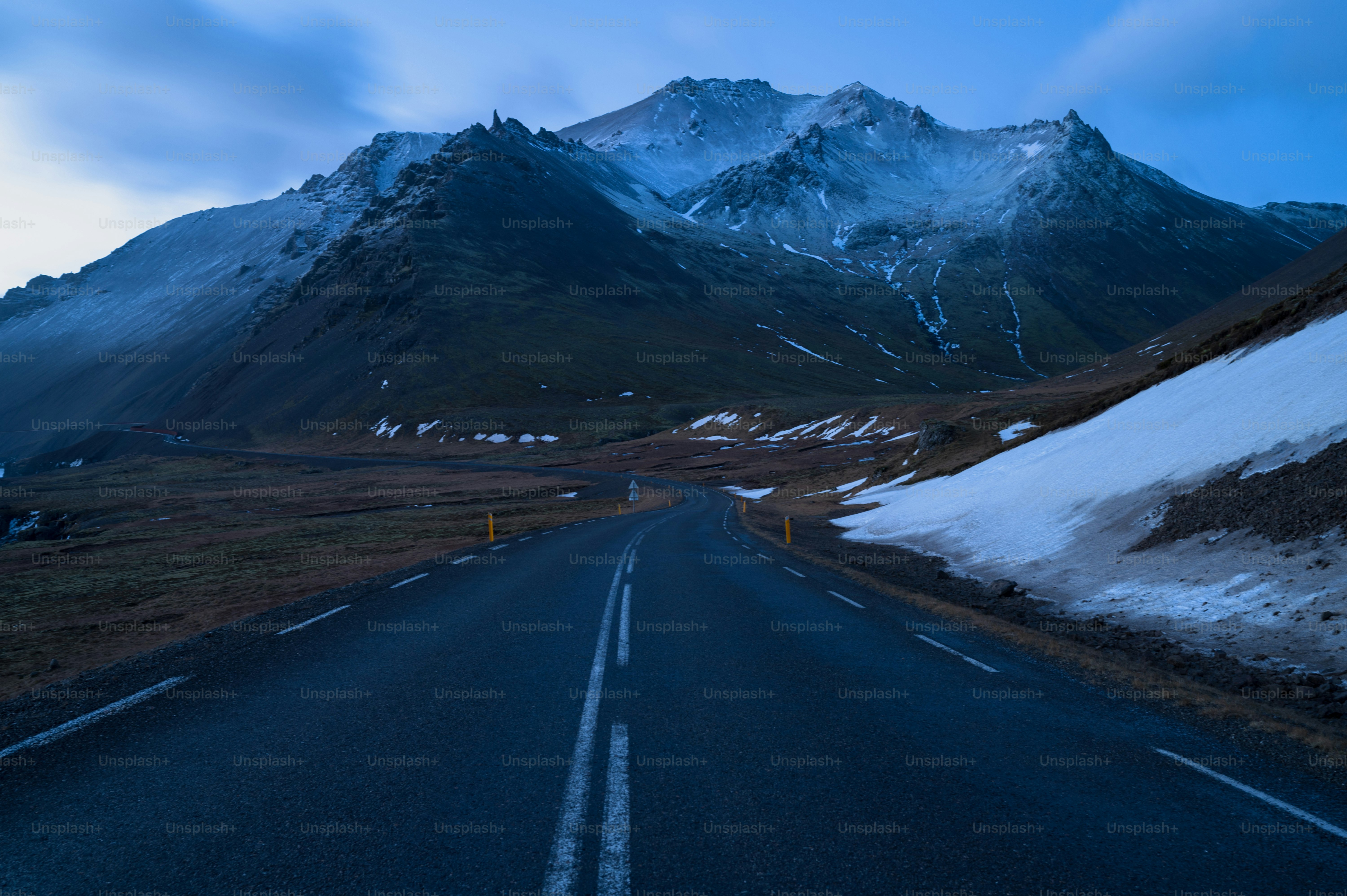 a road with a mountain in the background