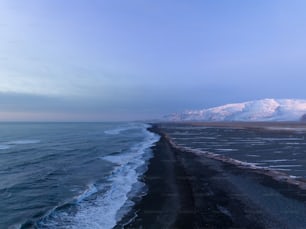 a large body of water with a mountain in the background