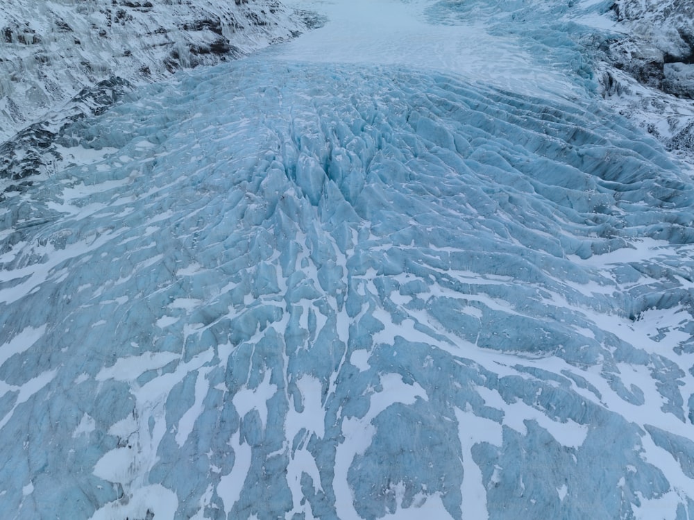 an aerial view of a glacier with snow on the ground