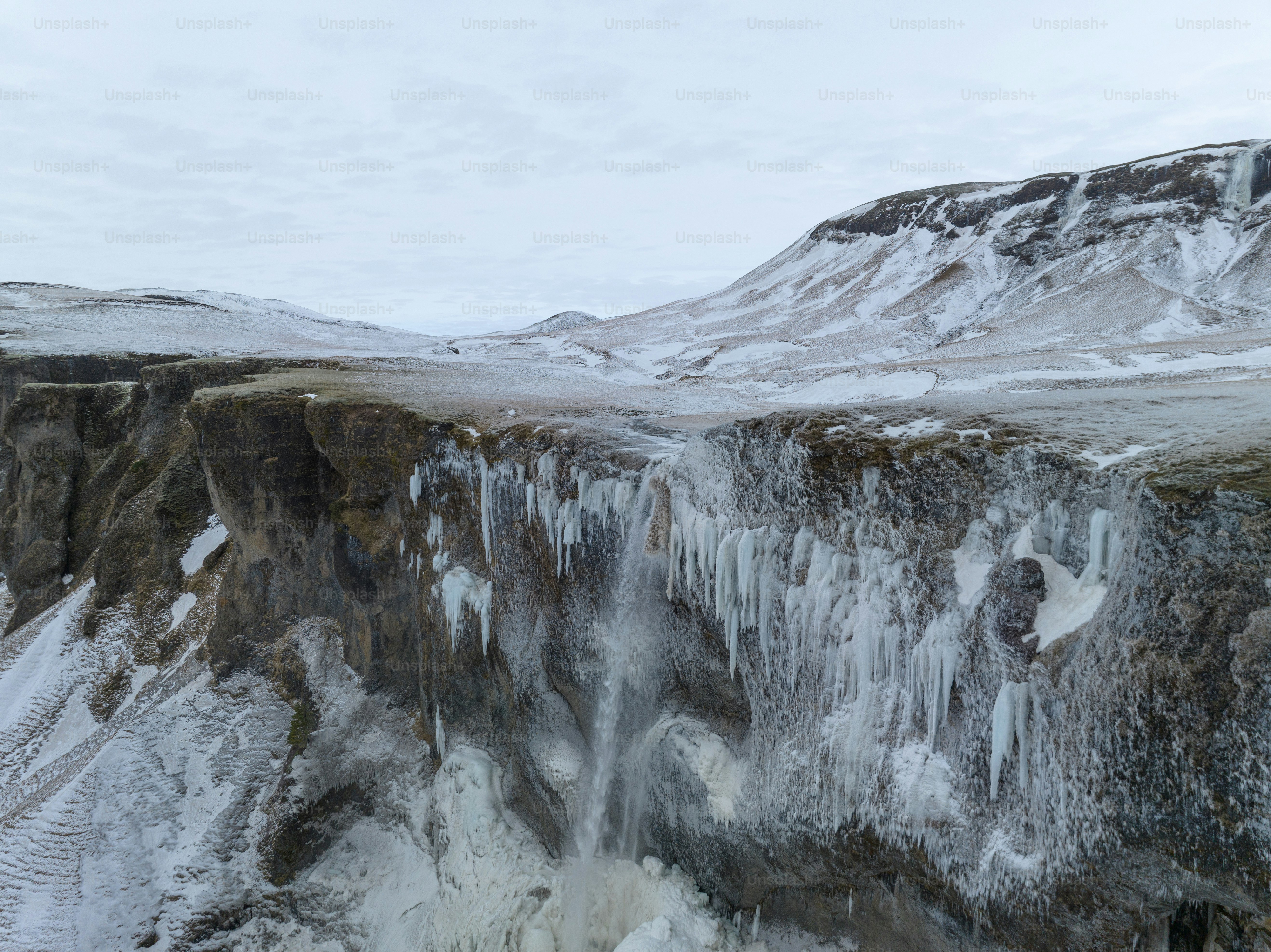 a very tall waterfall with ice on it