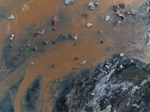 an aerial view of rocks and water in the desert