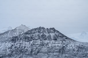 a mountain covered in snow on a cloudy day