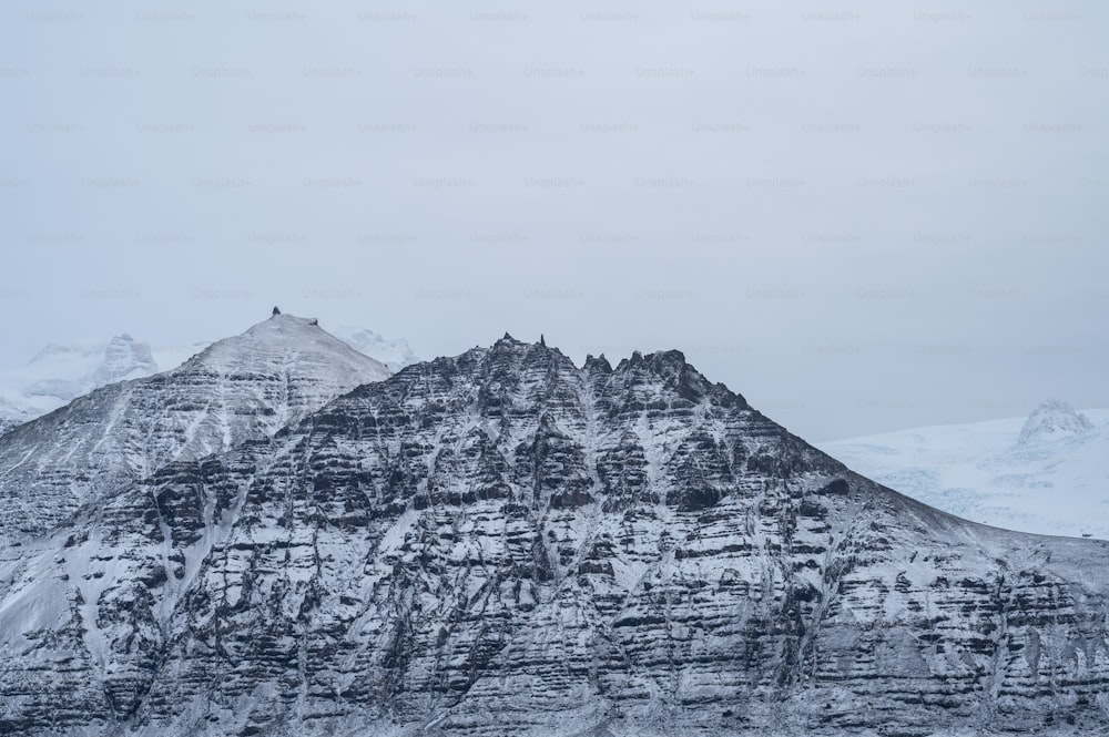 a mountain covered in snow on a cloudy day