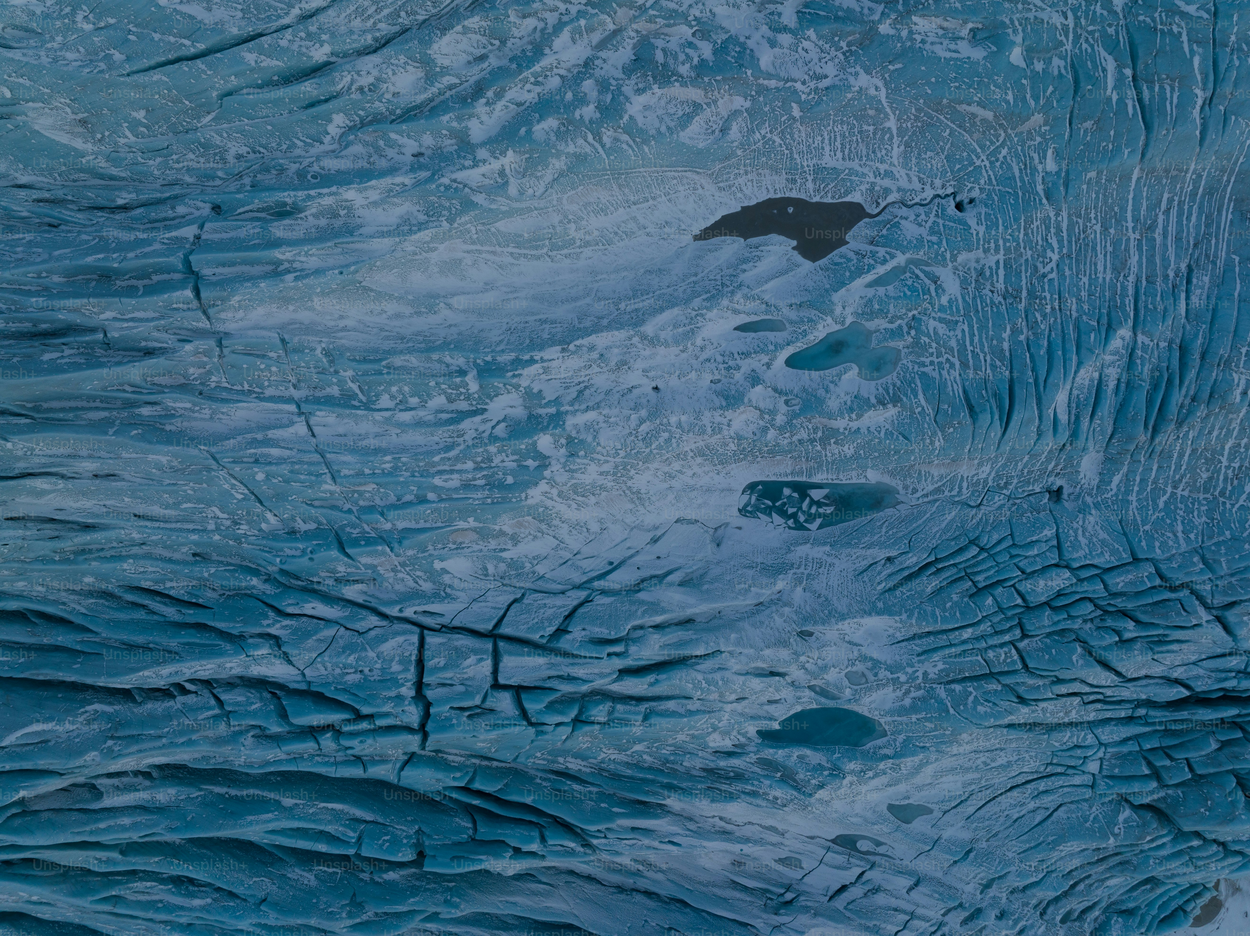 a large iceberg with a black umbrella on top of it