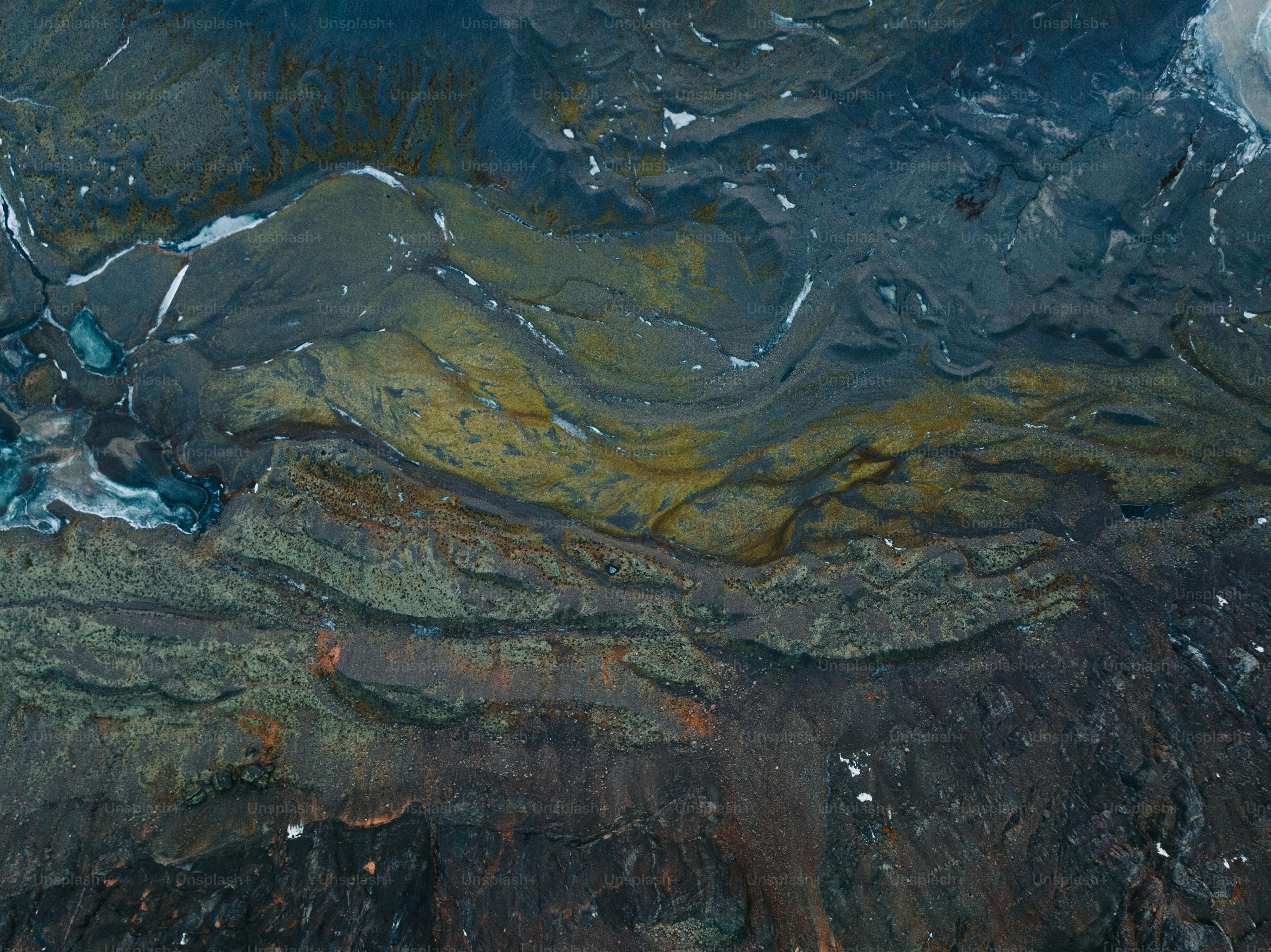 An aerial view of a snow covered mountain range photo – View from above ...
