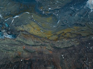 an aerial view of a mountain range covered in snow