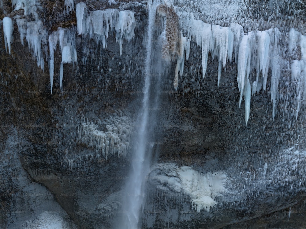 a waterfall with ice hanging off of it's sides