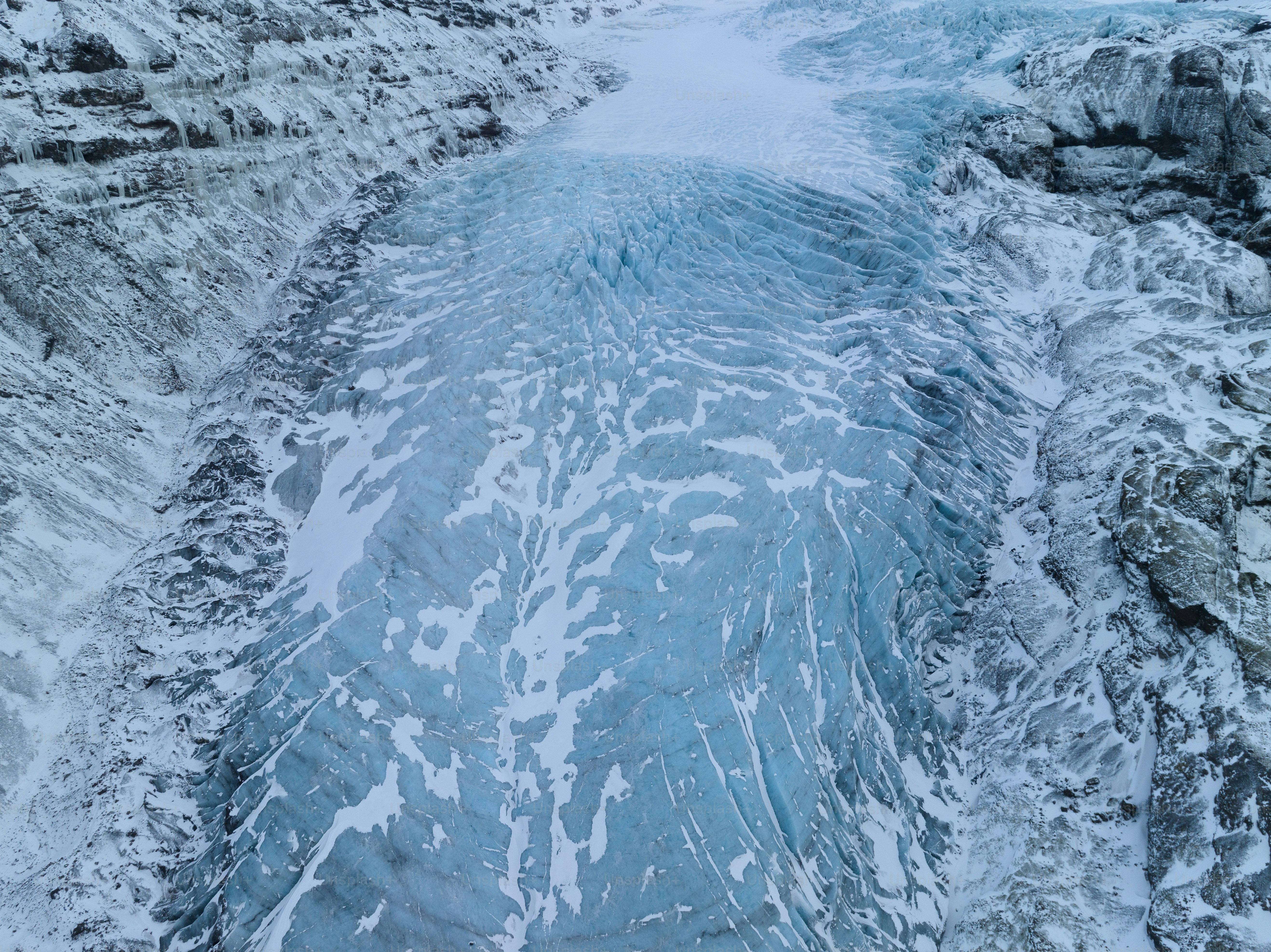 a large body of water surrounded by snow