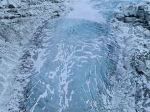 a large body of water surrounded by snow