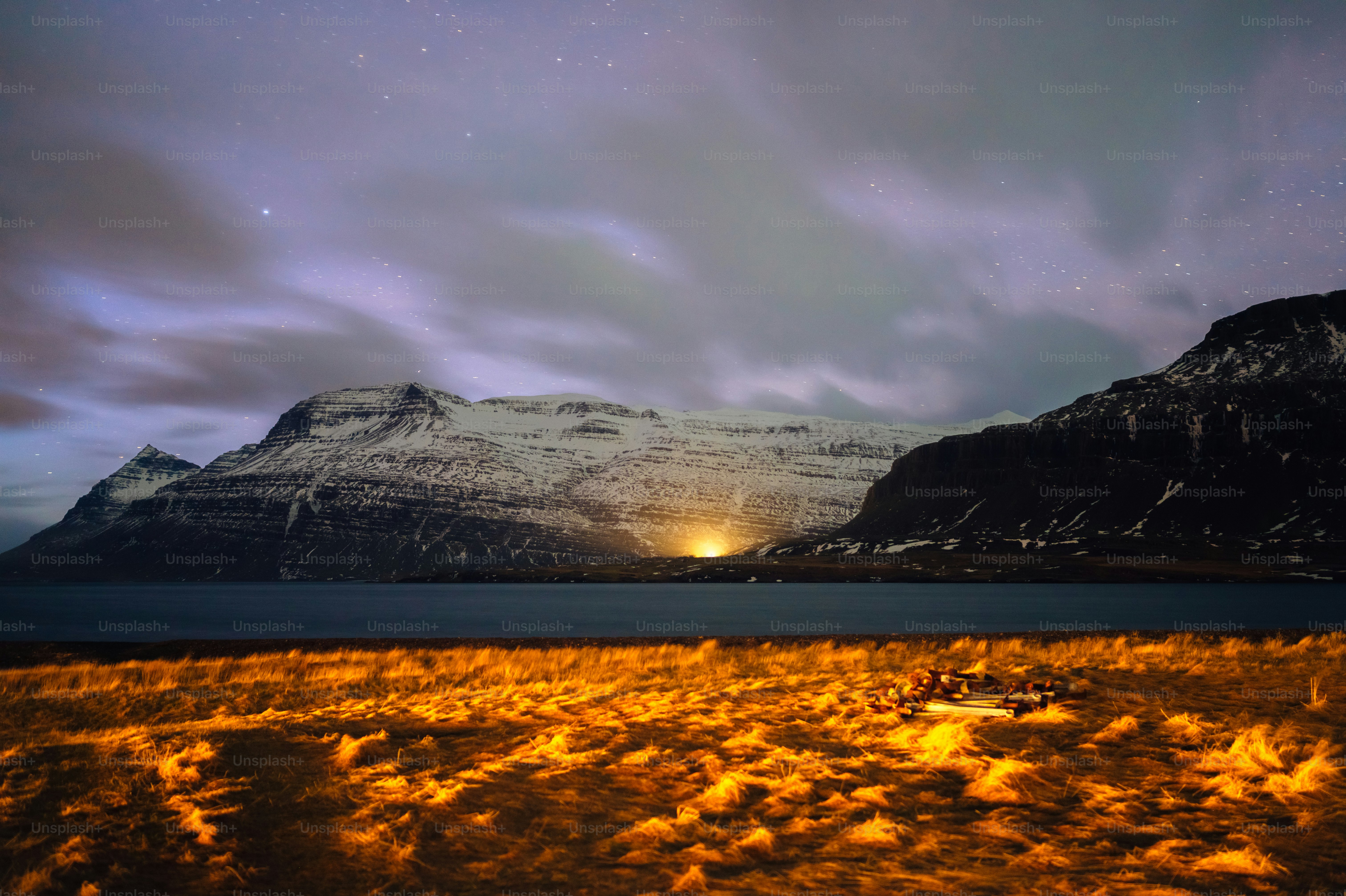 a field with a fire in the middle of it