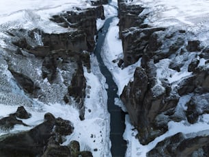 an aerial view of a river running between two mountains