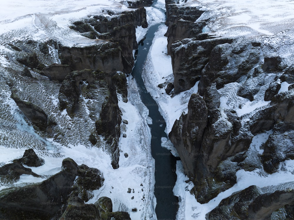 an aerial view of a river running between two mountains