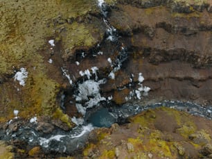 an aerial view of a stream in a rocky area