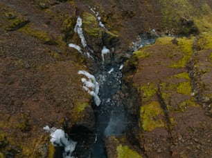 an aerial view of a stream in a rocky area