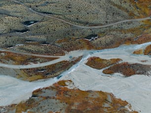 an aerial view of a winding road in the mountains