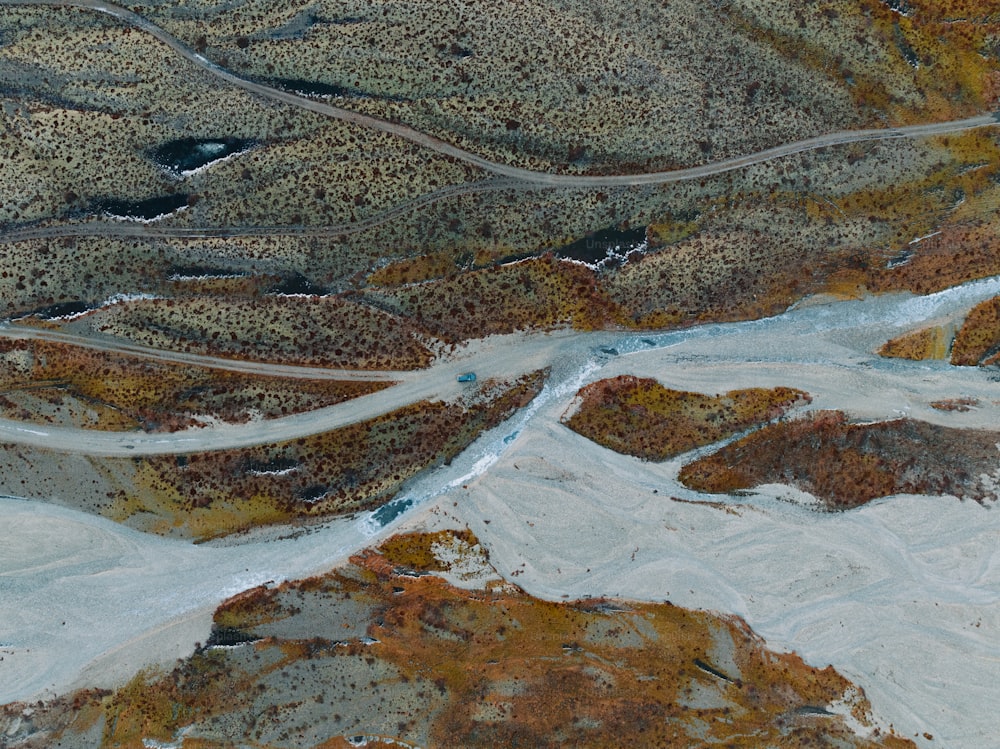 an aerial view of a winding road in the mountains