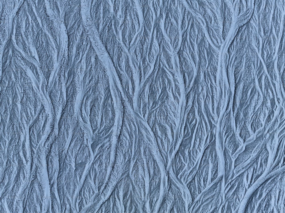 a close up of a blue wall with a pattern on it