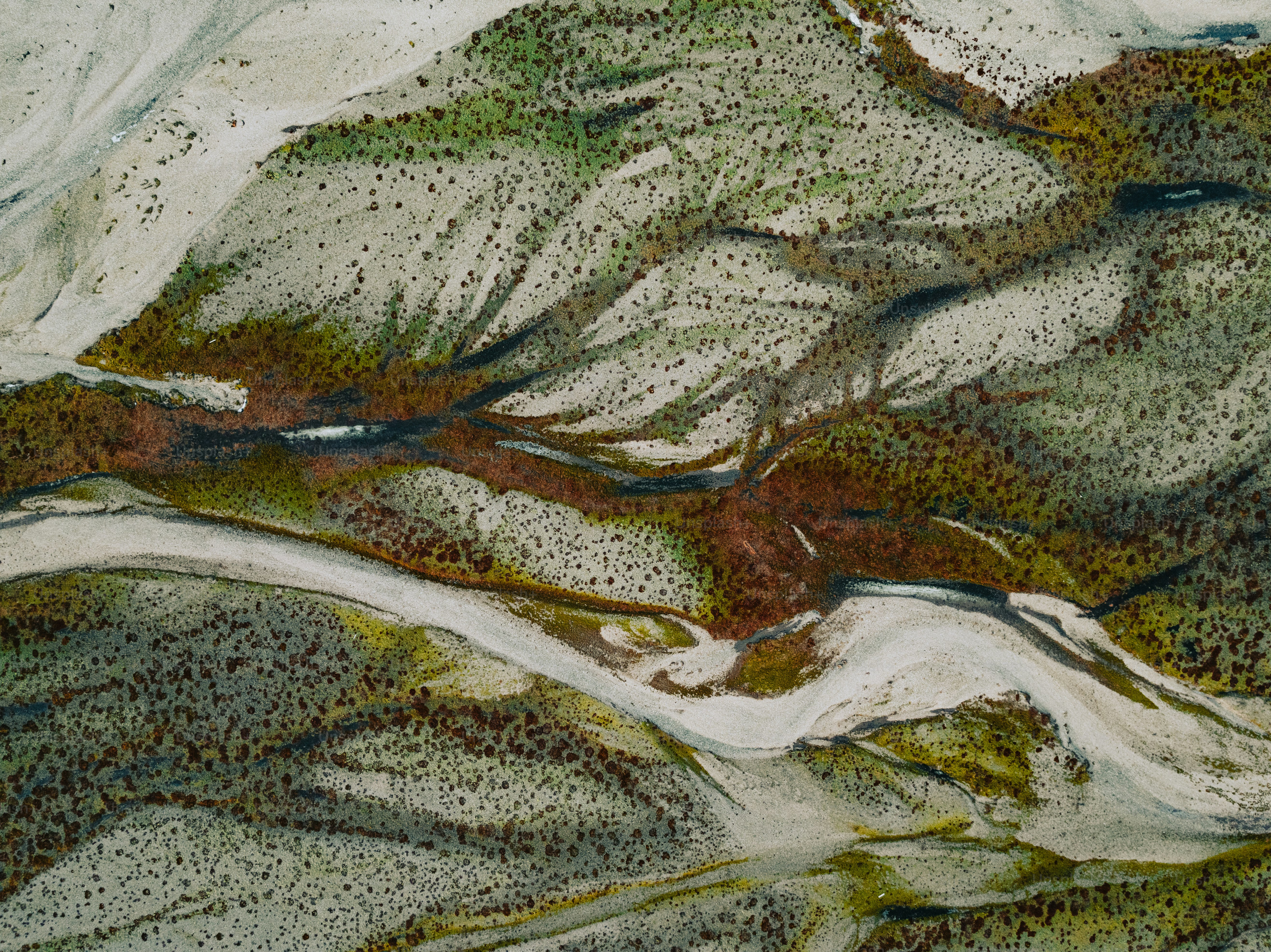 an aerial view of a snow covered mountain range