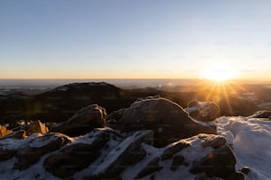 the sun is setting over a mountain range