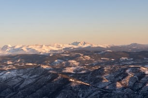 a view of a mountain range covered in snow