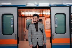 a man standing in front of a train door