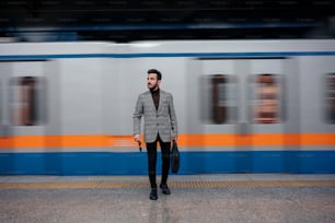 a man standing in front of a train