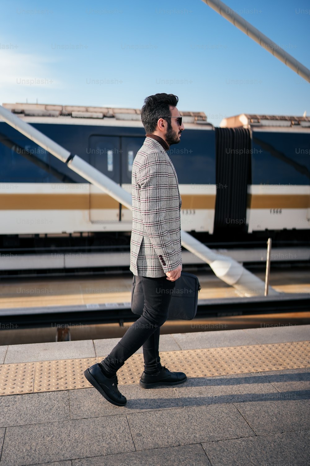 a man with a briefcase walking on a platform