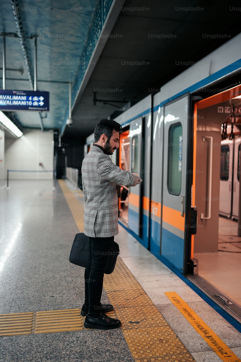 a man standing on a platform next to a train