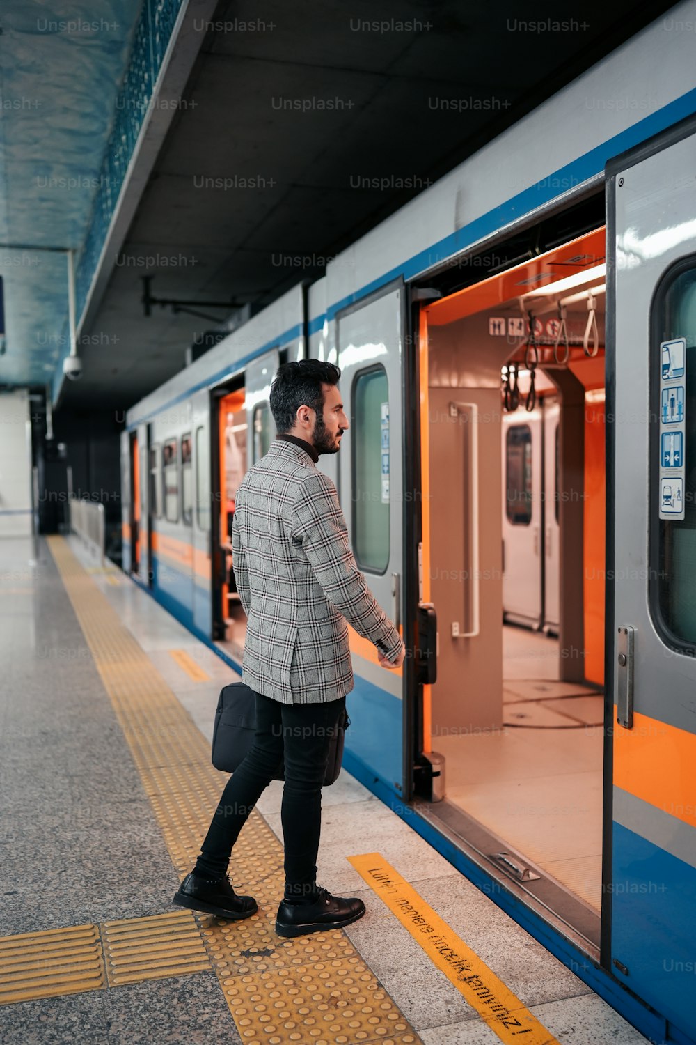 a man is getting on a train at the station